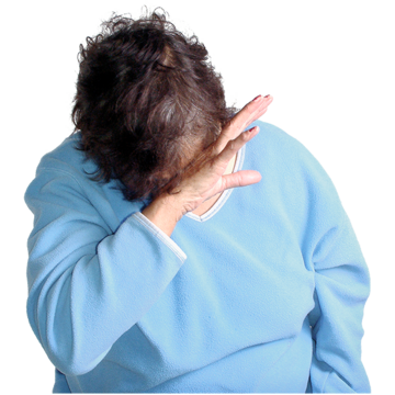 Am upset woman in a blue top hides her face with her hands