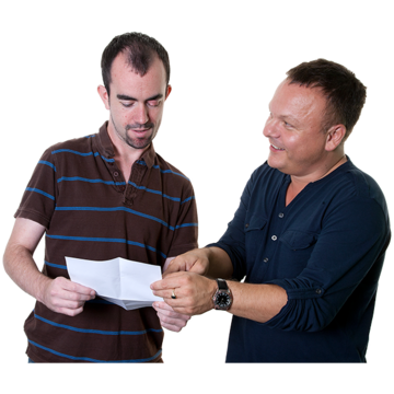 Two men standing next to each other. One is showing the other a piece of paper