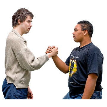 2 young males arm wrestling.
