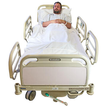 A man lying in a hospital bed.