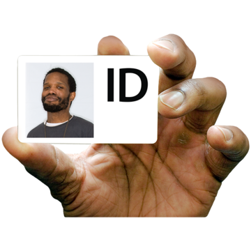 A hand holding a card with a photograph of a face and ID written on it.
