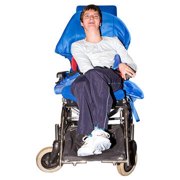 A lady with a learning disability in a moulded wheelchair.