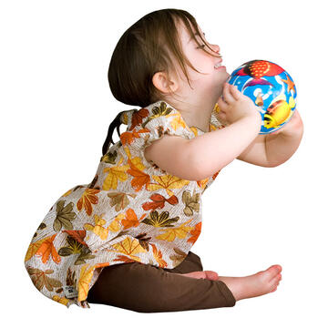 A young girl holding a ball.