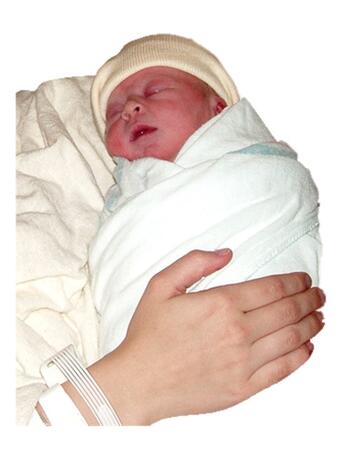 A young baby wrapped in a blanket and wearing a hat and being held.