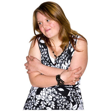 A girl folding her arms and looking to one side.