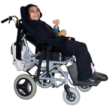 A girl in a moulded wheelchair smiling.