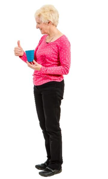 A lady holding a cup and putting her thumb up.