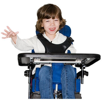 A young girl waving and smiling in a wheelchair which has a table or communication board on the front