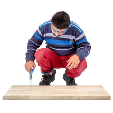 A man using a screwdriver in some wood.