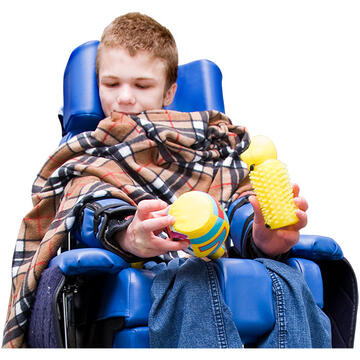 A young boy in a wheelchair holding 2 toys.