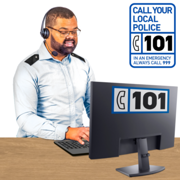A call operator sitting in front of a screen with a 101 poster behind