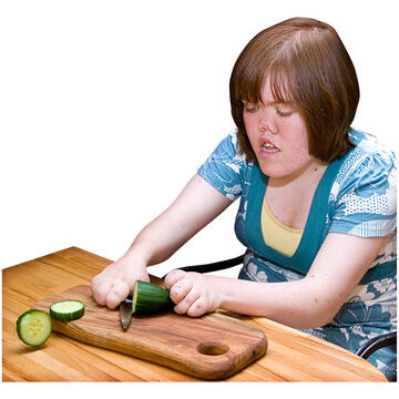 A lady slicing a cucumber