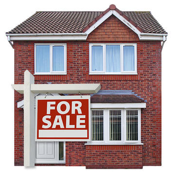 A house with a for sale sign outside.