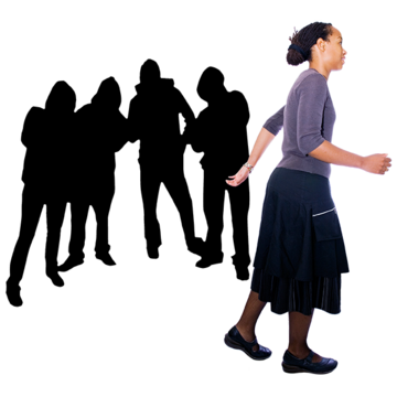 A woman walking past a gang