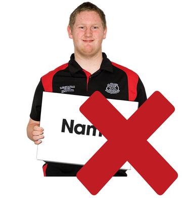 A red cross beside a man holding a sign saying name.