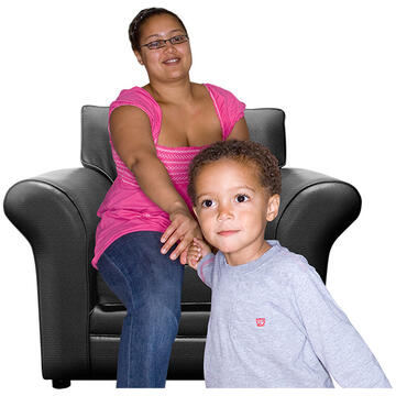 A child holding hands with his Mum who is sitting in a chair.