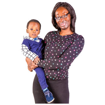 A woman holding a child on her hip.