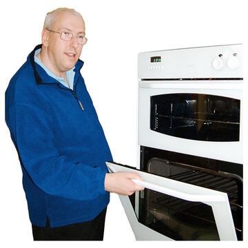A man opening an oven door.