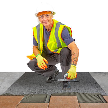 A woman laying tiles.