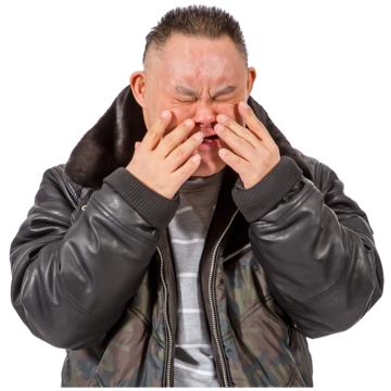 A man holding his hands to his face with a worried expression
