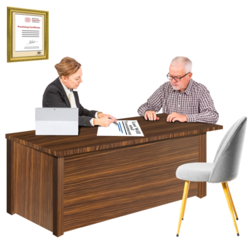 A man is sitting at the desk of a solicitor who is writing on a piece of paper with him.