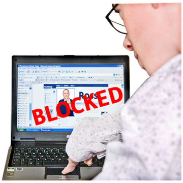 A man at a laptop pressing the keyboard. On the screen is a social media profile with BLOCKED in red letters across it