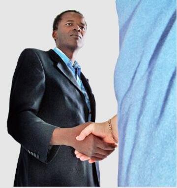 A man in a suit is shaking someone's hand