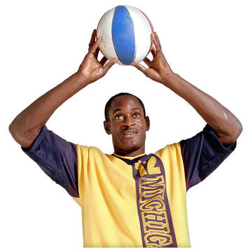 A man holding a basketball above his head.