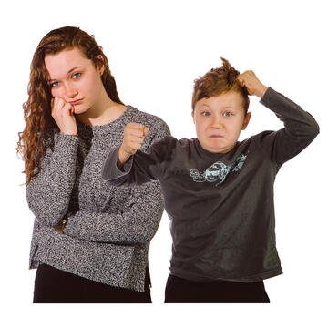 A young woman resting her chin on her hand and a young boy with his fists clenched with one hand against his head and the other hand punching in front of him.