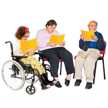 Three people sitting looking at what is in yellow folders.