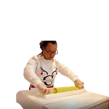 Michael rolling pastry with a rolling pin.