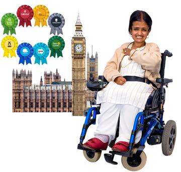 A woman in a wheelchair pointing to herself.  Behind her is the Houses of Parliament and rosettes from different political parties.