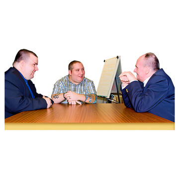 Three people sitting at a table talking.
