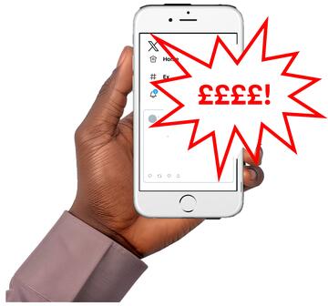 A hand holding a mobile phone which has pound signs and an exclamation mark on the screen.