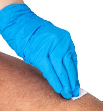 a gloved hand wiping an arm