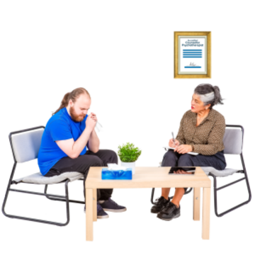 A man with his head in his hands is talking to a woman. They are sitting on opposite sides of a coffee table.