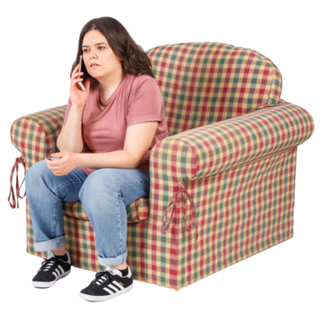 A woman sitting on a comfortable chair talking on a mobile phone