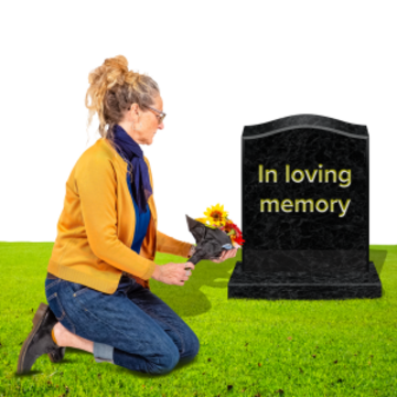 A woman kneeling next to a grave and putting flowers next to the gravestone