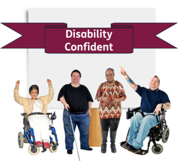 A group of disabled people in front of a Disability Confident banner
