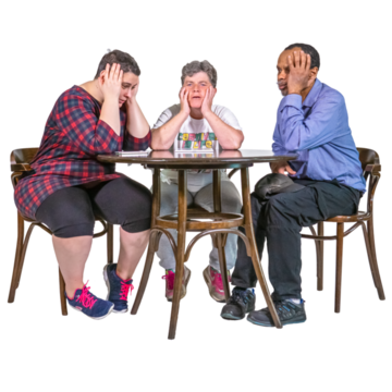 Three people sitting around a table looking fed up