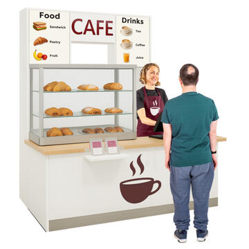 A man standing at a counter which has a lady and some pastries behind it and an image of a hot drink on the front of the counter.