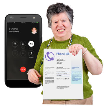 A woman holding up a phone bill with a mobile phone behind her.