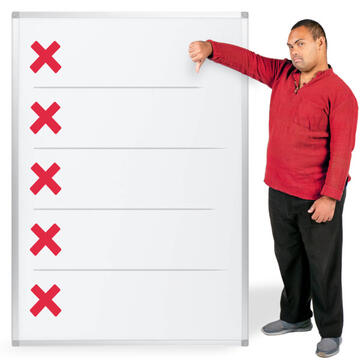 A man with his thumb down standing beside a sheet of paper that has red crosses on it.