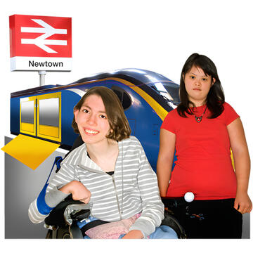 Two people standing on the platform in front of a train.