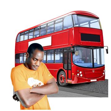 A man looking sad and crossing his arms with a bus behind him.