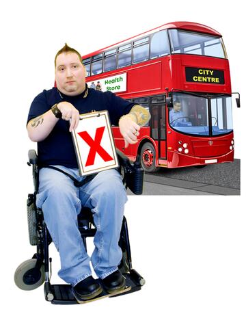 A man in a wheelchair holding a red cross and with his thumb down in front of a bus.