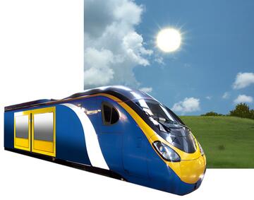 A train with a field and the sun behind it.