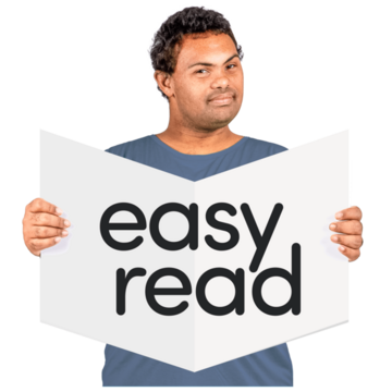 A man holding up an easy read booklet