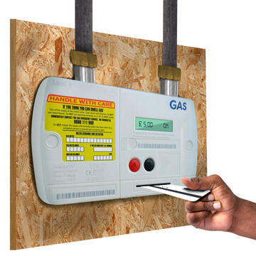 Someone putting a card into a gas meter.