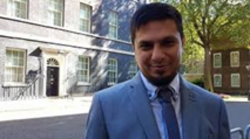 Ismail standing outside Number 10 Downing Street